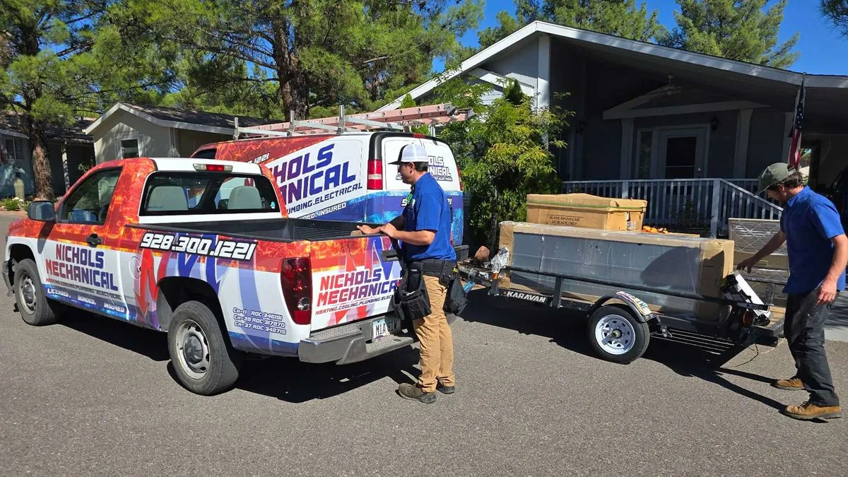 Nichols crew unloading a new HVAC system from a trailer