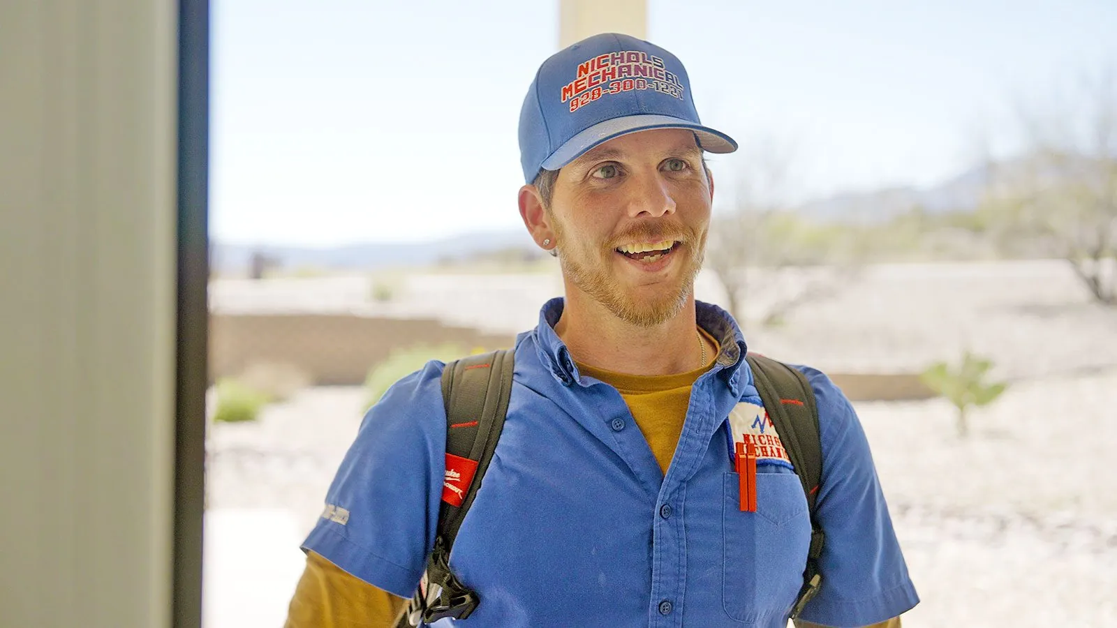 Smiling Nichols technician at a customer's door